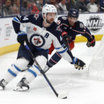 
              Winnipeg Jets defenseman Josh Morrissey, left, controls the puck in front of Columbus Blue Jackets forward Liam Foudy during the second period of an NHL hockey game in Columbus, Ohio, Thursday, Feb. 16, 2023. (AP Photo/Paul Vernon)
            