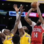 
              New Orleans Pelicans forward Brandon Ingram, right, shoots as Los Angeles Lakers forward Jarred Vanderbilt, left, and forward LeBron James defend during the first half of an NBA basketball game Wednesday, Feb. 15, 2023, in Los Angeles. (AP Photo/Mark J. Terrill)
            