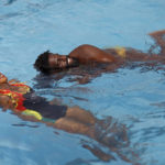 
              Prince Asante, the founder of Ghana's Awatu Winton Water Polo Club, demonstrates swimming lessons to girls in a swimming pool at the University of Ghana ahead of a competition in Accra, Ghana, Saturday, Jan. 14, 2023. Former water polo pro Prince Asante is training young players in the sport in his father's homeland of Ghana, where swimming pools are rare and the ocean is seen as dangerous. (AP Photo/Misper Apawu)
            