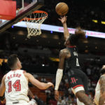 
              Houston Rockets guard Jalen Green (4) goes to the basket as Miami Heat guard Tyler Herro (14) and forward Caleb Martin (16) defend during the first half of an NBA basketball game Friday, Feb. 10, 2023, in Miami. (AP Photo/Lynne Sladky)
            