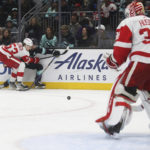 
              Detroit Red Wings defenseman Moritz Seider (53) collides with Seattle Kraken right wing Jordan Eberle as Red Wings goaltender Ville Husso (35) watches during the second period of an NHL hockey game Saturday, Feb. 18, 2023, in Seattle. (AP Photo/ Lindsey Wasson)
            