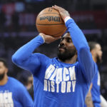 
              Dallas Mavericks guard Kyrie Irving smiles as he warms up prior to an NBA basketball game against the Los Angeles Clippers Wednesday, Feb. 8, 2023, in Los Angeles. (AP Photo/Mark J. Terrill)
            