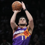 
              Phoenix Suns guard Devin Booker shoots a three-point basket during the second half of an NBA basketball game against the Brooklyn Nets, Tuesday, Feb. 7, 2023, in New York. The Suns won 116-112. (AP Photo/Mary Altaffer)
            