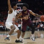 
              Florida State guard Darin Green Jr. (22) dribbles around Miami guard Harlond Beverly (5) during the first half of an NCAA college basketball game, Saturday, Feb. 25, 2023, in Coral Gables, Fla. (AP Photo/Marta Lavandier)
            