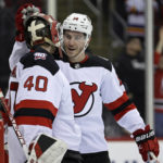 
              New Jersey Devils goaltender Akira Schmid (40) and Nathan Bastian celebrate after defeating the Philadelphia Flyers in an NHL hockey game Saturday, Feb. 25, 2023, in Newark, N.J. (AP Photo/Adam Hunger)
            