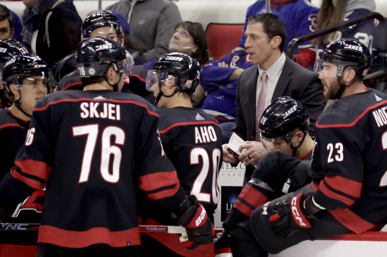 Carolina Hurricanes coach Rod Brind'Amour talks with player during a break in the action in the thi...