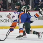 
              New York Islanders defenseman Sebastian Aho, front, battles for the puck against Minnesota Wild right wing Brandon Duhaime during the first period of an NHL hockey game Tuesday, Feb. 28, 2023, in St. Paul, Minn. (AP Photo/Abbie Parr)
            
