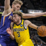 
              Indiana Pacers guard Chris Duarte (3) drives against Phoenix Suns center Jock Landale during the first half of an NBA basketball game in Indianapolis, Friday, Feb. 10, 2023. (AP Photo/Doug McSchooler)
            