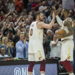 
              FILE - Cleveland Cavaliers' LeBron James, right, is congratulated by Kevin Love, after Jame's 867th consecutive game scoring in double figures during the first half of an NBA basketball game against the New Orleans Pelicans in Cleveland, Friday, March 30, 2018. James surpassed the old mark of 866 held by Michael Jordan. Cavaliers forward Love, in an essay for The Associated Press, reflected on his years as  James' teammate. James is about to pass Kareem Abdul-Jabbar for the NBA career scoring record. (AP Photo/Phil Long, File)
            