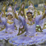 
              Dancers from the Aguia de Ouro samba school perform during a carnival parade in Sao Paulo, Brazil, Sunday, Feb. 19, 2023. (AP Photo/Andre Penner)
            