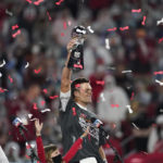 
              FILE - Tampa Bay Buccaneers quarterback Tom Brady holds up the Vince Lombardi trophy after defeating the Kansas City Chiefs in the NFL Super Bowl 55 football game, Feb. 7, 2021, in Tampa, Fla. Brady, the seven-time Super Bowl winner with New England and Tampa Bay, announced his retirement from the NFL on Wednesday, Feb. 1, 2023 exactly one year after first saying his playing days were over, by posting a brief video lasting just under one minute on social media. (AP Photo/Ashley Landis, File)
            