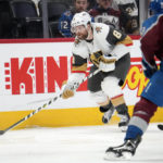
              Vegas Golden Knights right wing Phil Kessel, left, shoots as Colorado Avalanche center Nathan MacKinnon, right, defends in the second period of an NHL hockey game Monday, Feb. 27, 2023, in Denver. (AP Photo/David Zalubowski)
            