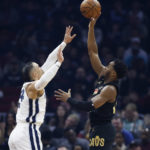 
              Cleveland Cavaliers guard Donovan Mitchell, right, shoots against Memphis Grizzlies forward Dillon Brooks during the first half of an NBA basketball game, Thursday, Feb. 2, 2023, in Cleveland. (AP Photo/Ron Schwane)
            