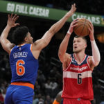
              Washington Wizards center Kristaps Porzingis, right, of Latvia, shoots against New York Knicks guard Quentin Grimes in the first half of an NBA basketball game, Friday, Feb. 24, 2023, in Washington. (AP Photo/Patrick Semansky)
            