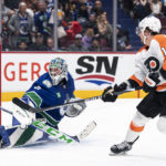
              Philadelphia Flyers' Travis Konecny, right, puts a backhand shot over the net behind Vancouver Canucks goalie Arturs Silovs during the second period of an NHL hockey game Saturday, Feb. 18, 2023, in Vancouver, British Columbia. (Rich Lam/The Canadian Press via AP)
            