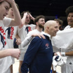 
              Saint Mary's head coach Randy Bennett, center, is congratulated by his players after notching his 500th career coaching victory, with a 68-59 victory over San Francisco in an NCAA college basketball game, Thursday, Feb. 2, 2023, in Moraga, Calif. (AP Photo/D. Ross Cameron)
            