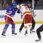 
              New York Rangers defenseman Jacob Trouba (8) and Calgary Flames center Dillon Dube (29) fight during the second period of an NHL hockey game, Monday, Feb. 6, 2023, in New York. (AP Photo/Noah K. Murray)
            