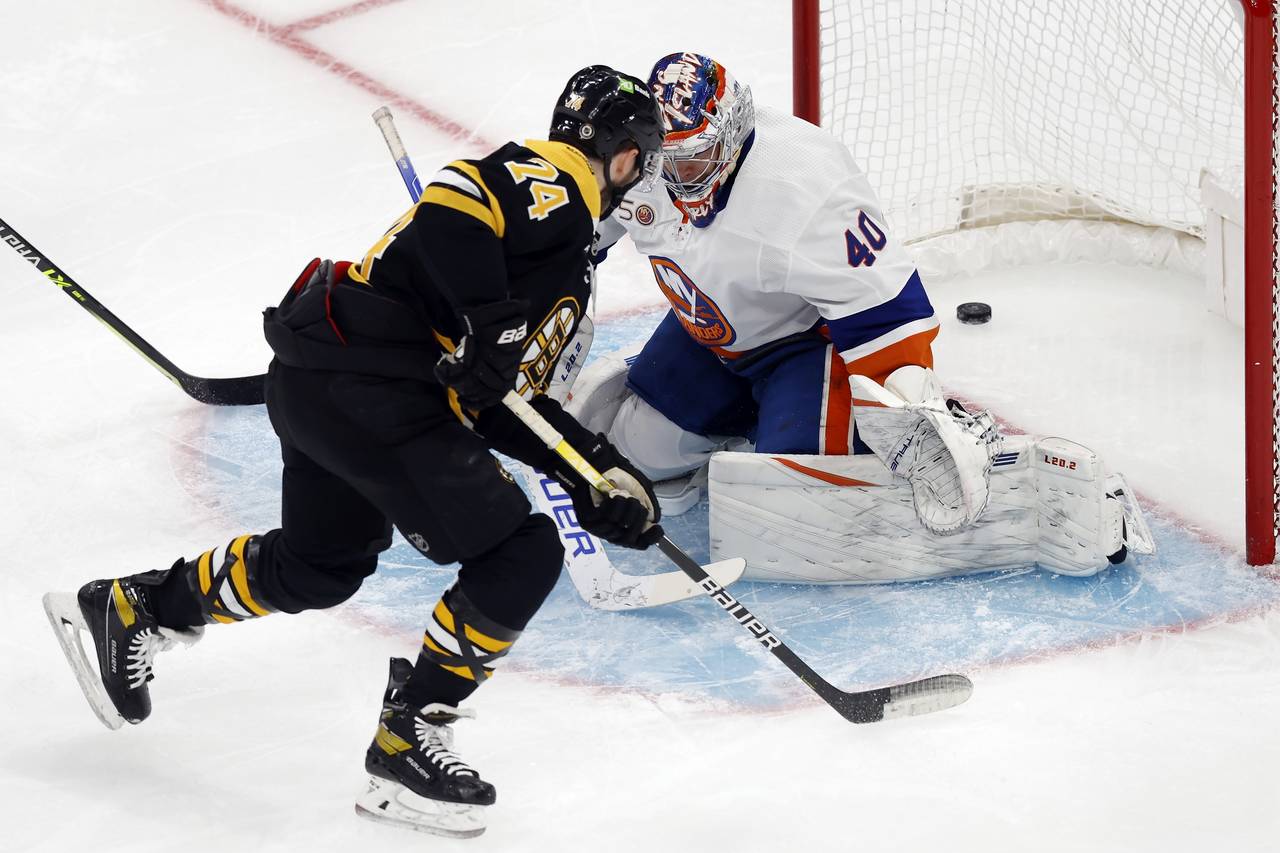 Boston Bruins' Jake DeBrusk (74) scores against New York Islanders goalie Semyon Varlamov (40) duri...