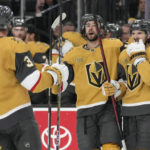 
              Vegas Golden Knights center Nicolas Roy, center, celebrates after scoring against the Tampa Bay Lightning during the third period of an NHL hockey game Saturday, Feb. 18, 2023, in Las Vegas. (AP Photo/John Locher)
            