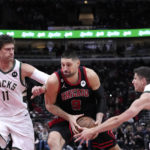 
              Chicago Bulls' Nikola Vucevic (9) drives to the basket between Milwaukee Bucks' Brook Lopez (11) and Grayson Allen during the first half of an NBA basketball game Thursday, Feb. 16, 2023, in Chicago. (AP Photo/Charles Rex Arbogast)
            