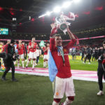 
              Manchester United's Lisandro Martinez celebrates with the trophy after the English League Cup final soccer match between Manchester United and Newcastle United at Wembley Stadium in London, Sunday, Feb. 26, 2023. (AP Photo/Alastair Grant)
            