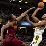
              Indiana Pacers center Myles Turner shoots over Cleveland Cavaliers forward Evan Mobley during the second half of an NBA basketball game in Indianapolis, Sunday, Feb. 5, 2023. The Cavaliers won 122-103.(AP Photo/AJ Mast)
            