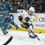 
              Chicago Blackhawks center Max Domi (13) gets possession of the puck from San Jose Sharks center Nick Bonino (13) during the first period of an NHL hockey game in San Jose, Calif., Saturday, Feb. 25, 2023. (AP Photo/John Hefti)
            