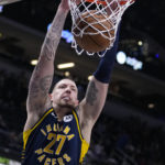 
              Indiana Pacers center Daniel Theis (27) gets a dunk against the Utah Jazz during the first half of an NBA basketball game in Indianapolis, Monday, Feb. 13, 2023. (AP Photo/Michael Conroy)
            