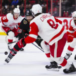 
              Ottawa Senators right wing Claude Giroux (28) skates the puck upice as Detroit Red Wings Ben Chiarot (8) defends during second-period NHL hockey game action in Ottawa, Ontario, Monday, Feb. 27, 2023. (Sean Kilpatrick/The Canadian Press via AP)
            