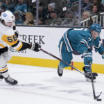 
              Pittsburgh Penguins defenseman Kris Letang, left, and San Jose Sharks center Nico Sturm chase after the puck during the first period of an NHL hockey game in San Jose, Calif., Tuesday, Feb. 14, 2023. (AP Photo/Godofredo A. Vásquez)
            