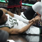 
              Milwaukee Bucks' Giannis Antetokounmpo lies by the basket after injuring his right hand during the first half of the team's NBA basketball game against the Chicago Bulls on Thursday, Feb. 16, 2023, in Chicago. (AP Photo/Charles Rex Arbogast)
            