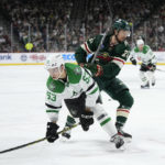 
              Dallas Stars center Wyatt Johnston (53) is pushed by Minnesota Wild right wing Brandon Duhaime (21) during the second period of an NHL hockey game Friday, Feb. 17, 2023, in St. Paul, Minn. (AP Photo/Abbie Parr)
            