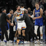 
              Minnesota Timberwolves guard Austin Rivers, middle, is held back after participating in a scrum with Orlando Magic players during the second half of an NBA basketball game, Friday, Feb. 3, 2023, in Minneapolis. (AP Photo/Abbie Parr)
            