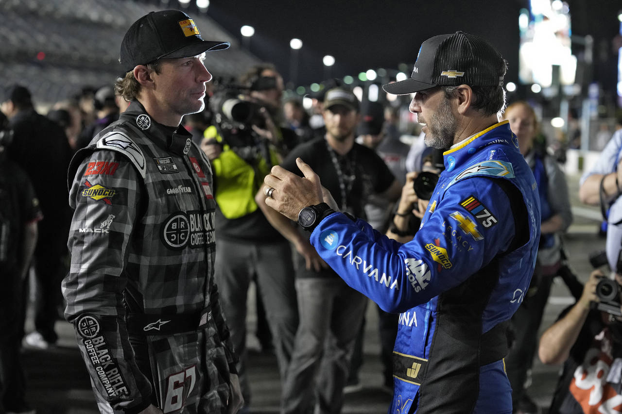 Jimmie Johnson, right, and Travis Pastrana talk before qualifying for the NASCAR Daytona 500 auto r...