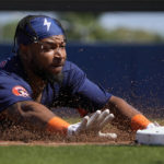 
              Houston Astros' Corey Julks reaches for third as he dives in for a triple during the second inning of a spring training baseball game against the Miami Marlins Monday, Feb. 27, 2023, in West Palm Beach, Fla. (AP Photo/Jeff Roberson)
            