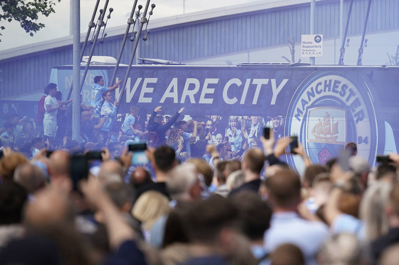 FILE - Fans welcome Manchester City players before the start of the English Premier League soccer m...