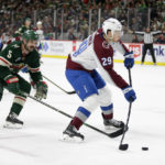 
              Colorado Avalanche center Nathan MacKinnon (29) shoots a goal with Minnesota Wild defenseman Jake Middleton (5) looking on in the second period of an NHL hockey game Wednesday, Feb. 15, 2023, in St. Paul, Minn. (AP Photo/Andy Clayton-King)
            