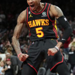 
              Atlanta Hawks guard Dejounte Murray (5) reacts after a basket Cleveland Cavaliers during the first half of an NBA basketball game Friday, Feb. 24, 2023, in Atlanta. (AP Photo/John Bazemore)
            