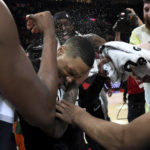 
              Portland Trail Blazers guard Damian Lillard, center, is doused by teammates after setting franchise and career highs with 71 points during an NBA basketball game against the Houston Rockets in Portland, Ore., Sunday, Feb. 26, 2023. (AP Photo/Steve Dykes)
            