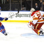 
              New York Rangers center Filip Chytil (72) scores a goal against Calgary Flames goaltender Jacob Markstrom (25) during the second period of an NHL hockey game, Monday, Feb. 6, 2023, in New York. (AP Photo/Noah K. Murray)
            