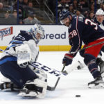 
              Winnipeg Jets goalie David Rittich, left, stops a shot in front of Columbus Blue Jackets forward Boone Jenner during the second period of an NHL hockey game in Columbus, Ohio, Thursday, Feb. 16, 2023. (AP Photo/Paul Vernon)
            