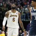 
              Los Angeles Lakers forward LeBron James (6) laughs next to Dallas Mavericks forward Christian Wood (35) during the second half of an NBA basketball game in Dallas, Sunday, Feb. 26, 2023. (AP Photo/LM Otero)
            