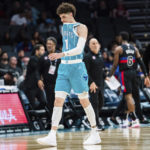 
              Charlotte Hornets guard LaMelo Ball walks off the court after being shaken up on a play during the second half of an NBA basketball game against the Detroit Pistons in Charlotte, N.C., Monday, Feb. 27, 2023. (AP Photo/Jacob Kupferman)
            