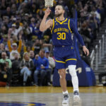 
              Golden State Warriors guard Stephen Curry (30) gestures after scoring against the Dallas Mavericks during the second half of an NBA basketball game in San Francisco, Saturday, Feb. 4, 2023. (AP Photo/Jeff Chiu)
            