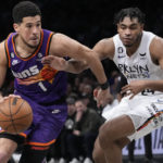 
              Phoenix Suns guard Devin Booker (1) drives against Brooklyn Nets guard Cam Thomas (24) during the second half of an NBA basketball game, Tuesday, Feb. 7, 2023, in New York. The Suns won 116-112. (AP Photo/Mary Altaffer)
            