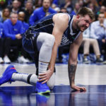 
              Dallas Mavericks guard Luka Doncic grabs his right foot after an awkward fall during the second half of an NBA basketball game against the New Orleans Pelicans, Thursday, Feb. 2, 2023, in Dallas. Doncic left the game shortly afterward with a right heel contusion. (AP Photo/Brandon Wade)
            