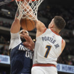 
              Dallas Mavericks center JaVale McGee, back, dunks the ball for a basket as Denver Nuggets forward Michael Porter Jr. defends in the first half of an NBA basketball game Wednesday, Feb. 15, 2023, in Denver. (AP Photo/David Zalubowski)
            