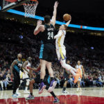 
              Golden State Warriors guard Donte DiVincenzo, right, heads for a dunk against Portland Trail Blazers forward Drew Eubanks during the first half of an NBA basketball game in Portland, Ore., Wednesday, Feb. 8, 2023. (AP Photo/Craig Mitchelldyer)
            