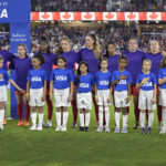 
              Canada players wear purple shirts with "Enough is Enough" written on them during the Canadian national anthem before the team's SheBelieves Cup women's soccer match against the United States, Thursday, Feb. 16, 2023, in Orlando, Fla. (AP Photo/Phelan M. Ebenhack)
            