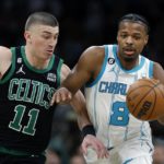 
              Charlotte Hornets' Dennis Smith Jr. (8) drives past Boston Celtics' Payton Pritchard (11) during the first half of an NBA basketball game Friday, Feb. 10, 2023, in Boston. (AP Photo/Michael Dwyer)
            